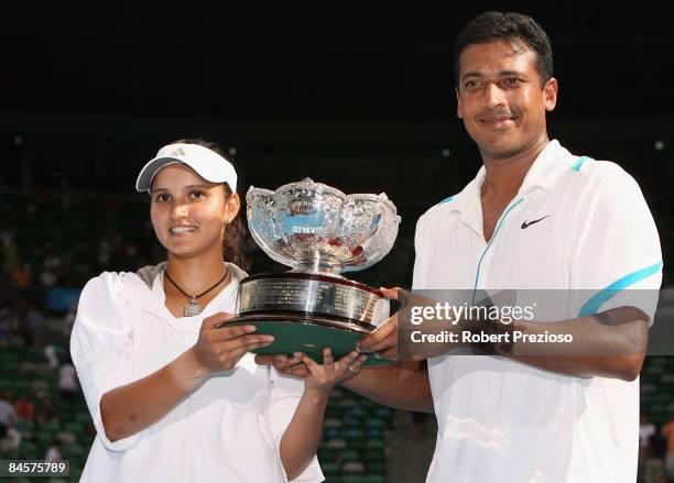 Sania Mirza and Mahesh Bhupathi of India pose with the championship trophy after winning their mixed doubles final match against Nathalie Dechy of...