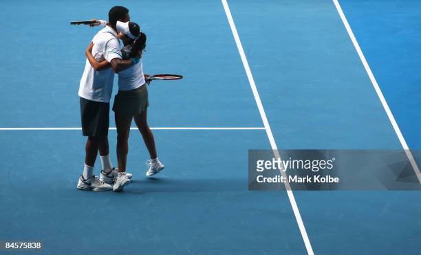 Sania Mirza and Mahesh Bhupathi of India celebrate winning championship point in their mixed doubles final match against Nathalie Dechy of France and...
