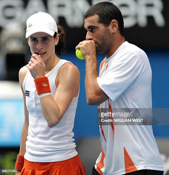 Andy Ram of Israel and Nathalie Dechy of France communicate during their game against Sania Mirza and Mahesh Bhupathi of India in the mixed doubles...