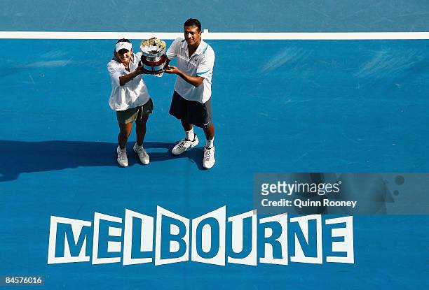 Sania Mirza and Mahesh Bhupathi of India pose with the championship trophy after winning their mixed doubles final match against Nathalie Dechy of...