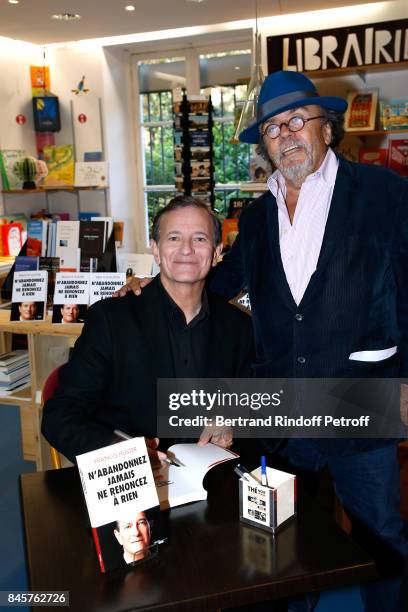 Actor Francis Huster and Director of the "Theatre du Rond-Point" Jean-Michel Ribes attend Francis Huster signs his Book "N'abandonnez jamais, ne...