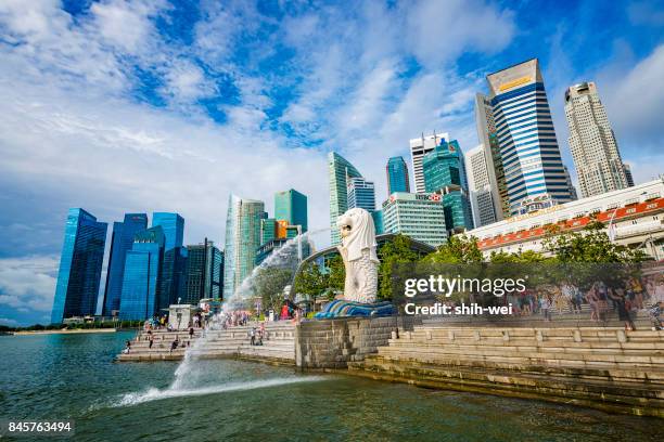 marina bay, singapore "u2013 5/22/2014: view of the business district and the merlion park & moving clounds at night with singapore city background. the merlion is the national personification of singapore - merlion park stock pictures, royalty-free photos & images