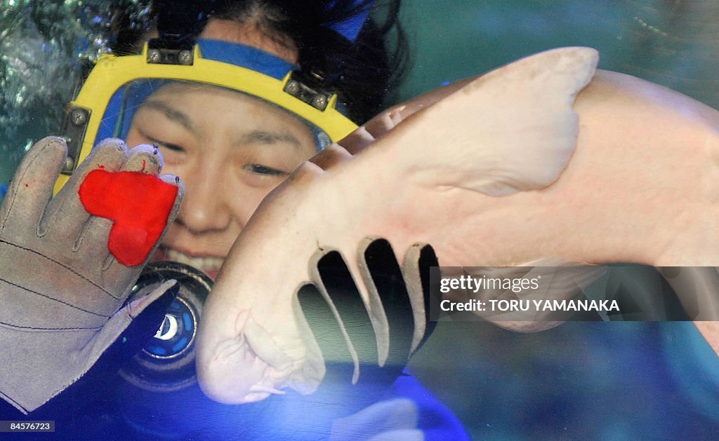 A female diver presents a red heart-shap