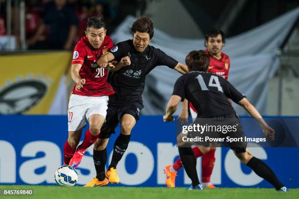 Guangzhou Evergrande midfielder Yu Hanchao fights for the ball with Seongnam FC defender Lim Chaimin during the 2015 AFC Champions League Round of 16...