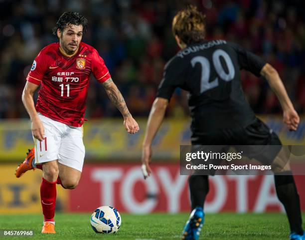 Guangzhou Evergrande midfielder Goulart Pereira fights for the ball with Seongnam FC defender Young Sun during the 2015 AFC Champions League Round of...