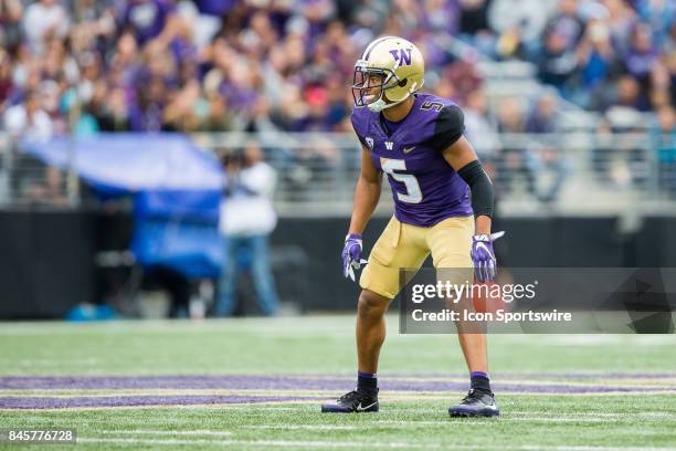 Washington Myles Bryant looks in at the Montana quarterback during a college football game between the Washington Huskies and the Montana Grizzlies...