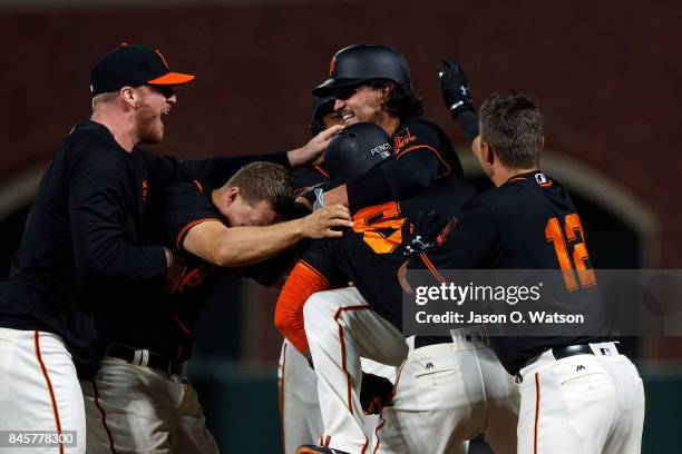 Jarrett Parker of the San Francisco Giants is congratulated by teammates after hitting a walk off single in the tenth inning against the Arizona...