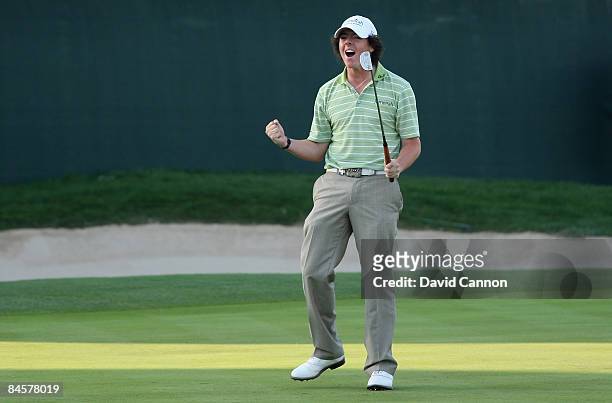 Rory McIlroy of Northern Ireland celebrates on the 18th green after winning the 2009 Dubai Desert Classic on the Majilis Course at the Emirates Golf...