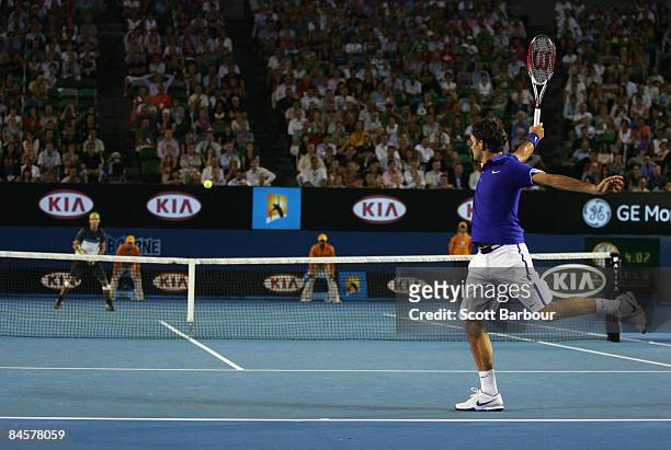 Roger Federer of Switzerland plays a backhand in his men's final match against Rafael Nadal of Spain during day fourteen of the 2009 Australian Open...
