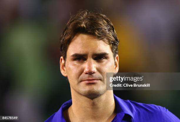 Roger Federer of Switzerland shows his emotion during the trophy presentation after his men's final match against Rafael Nadal of Spain during day...