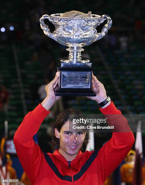 Rafael Nadal of Spain holds aloft the Norman Brookes Challenge Cup after winning his men's final match against Roger Federer of Switzerland during...