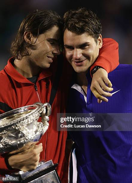 Rafael Nadal of Spain consoles Roger Federer of Switzerland during the trophy presentation after his men's final match during day fourteen of the...