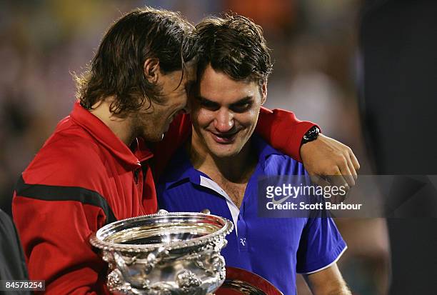 Rafael Nadal of Spain consoles Roger Federer of Switzerland during the trophy presentation after his men's final match during day fourteen of the...