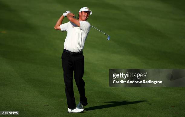 Richard Green of Australia hits his second shot on the 14th hole during the final round of the Dubai Desert Classic on the Majilis course at Emirates...