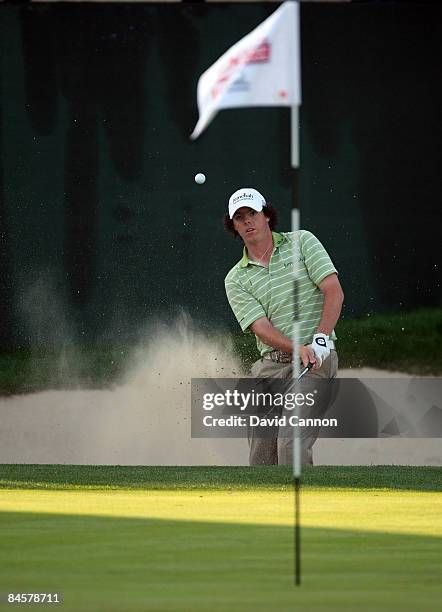 Rory McIlroy of Northern Ireland plays his fourth shot on the 18th hole during the final round of the 2009 Dubai Desert Classic on the Majilis Course...