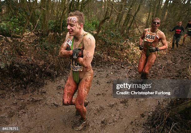 Competitors in their 'mankinis' feel the cold while running during the Tough Guy Challenge 2009 at South Perton Farm on February 1, 2009 in...