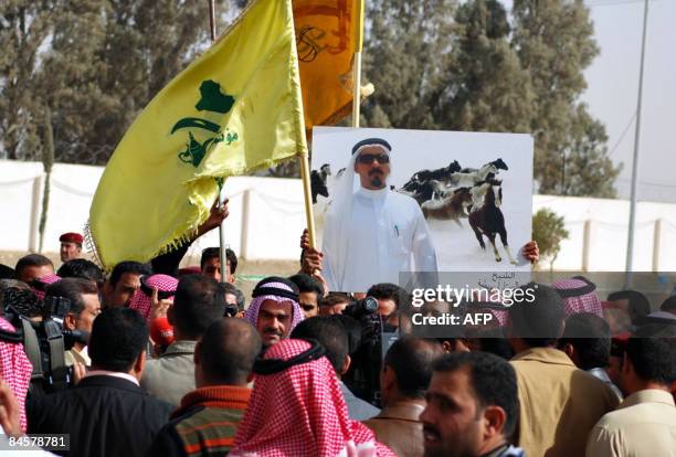 Sunni Muslim Iraqis and members of the Sahwa or Sons of Iraq celebrate as they hold up an image of killed tribal leader Abdul Sattar Abu Risha...