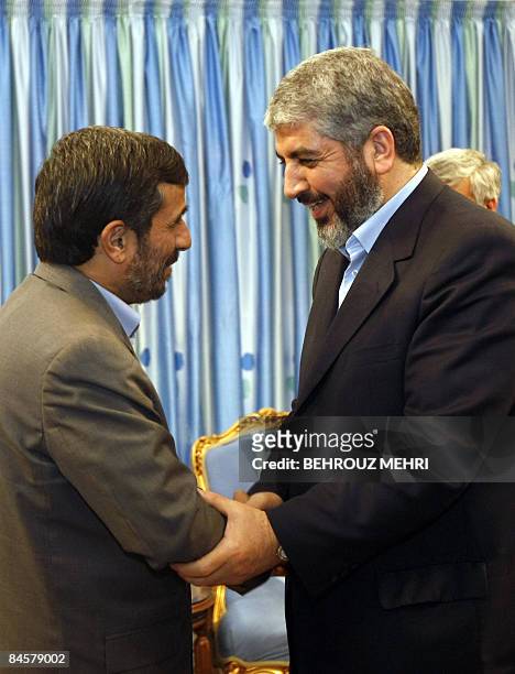 Iranian President Mahmoud Ahmadinejad welcomes the political supremo of Palestinian Islamist movement Hamas, Khaled Meshaal, upon his arrival for a...