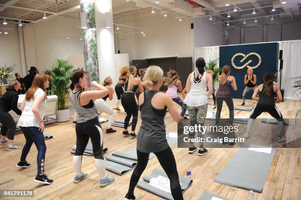 Lead designer, Carrie Underwood and her road trainer, Eve Overland lead a group workout to celebrate the lines Fall/Winter 17 collection at West...