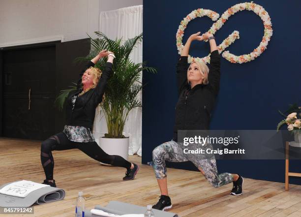 Lead designer, Carrie Underwood and her road trainer, Eve Overland lead a group workout to celebrate the lines Fall/Winter 17 collection at West...