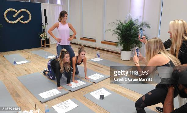 Audrina Patridge Bohan, Becca Tilley and Christine Andrew warm up before their workout with CALIA lead designer, Carrie Underwood and her road...