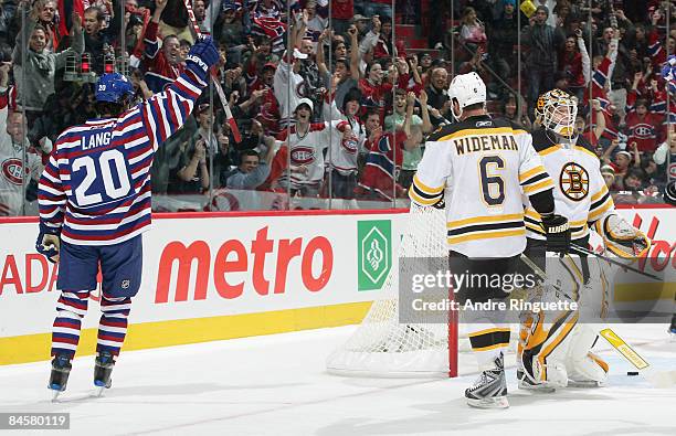 Robert Lang of the Montreal Canadiens celebrates his first period goal as Dennis Wideman and Tim Thomas of the Boston Bruins react at the Bell Centre...