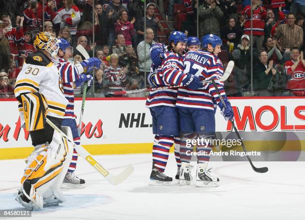 Robert Lang of the Montreal Canadiens celebrates his first period goal against Tim Thomas of the Boston Bruins with teammate Alexei Kovalev at the...