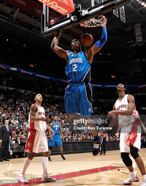 Dwight Howard of the Orlando Magic throws down the two-handed slam dunk ahead of Jamario Moon and Chris Bosh of the Toronto Raptors on February 1,...