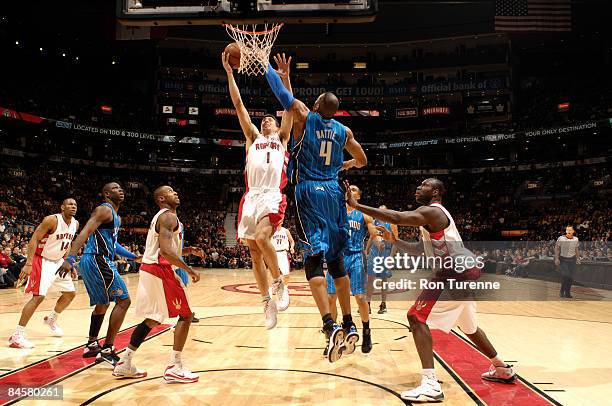 Roko Ukic of the Toronto Raptors gets into the lane for the layup against Tony Battie of the Orlando Magic on February 1, 2009 at the Air Canada...