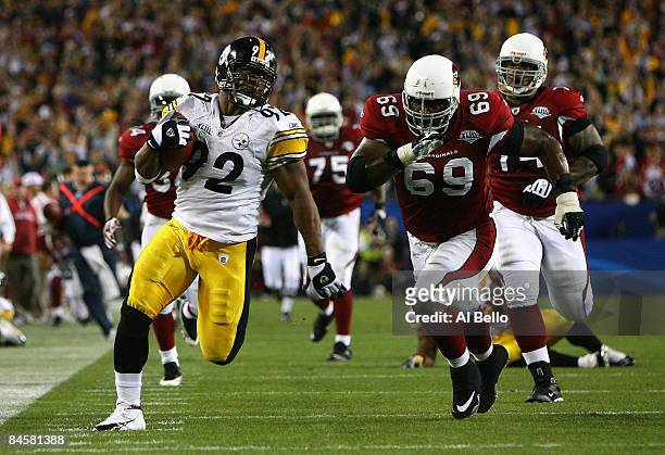 James Harrison of the Pittsburgh Steelers runs back an interception for a touchdown in the second quarter against Mike Gandy of the Arizona Cardinals...