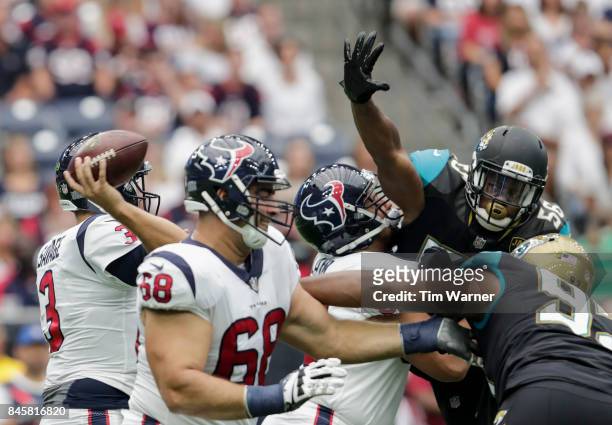 Tom Savage of the Houston Texans looks to pass as Dante Fowler of the Jacksonville Jaguars applies pressure in the first quarter at NRG Stadium on...