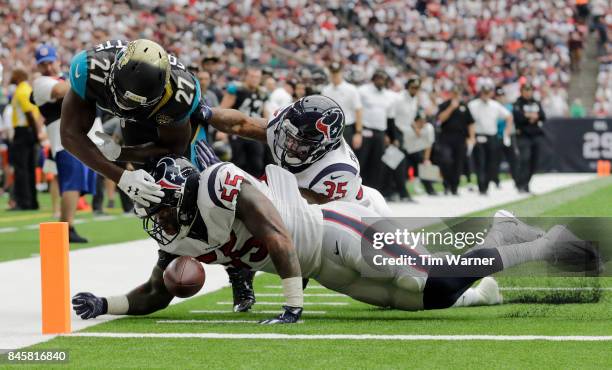 Leonard Fournette of the Jacksonville Jaguars dives toward the end zone and loses control of the ball after a hit by Benardrick McKinney of the...