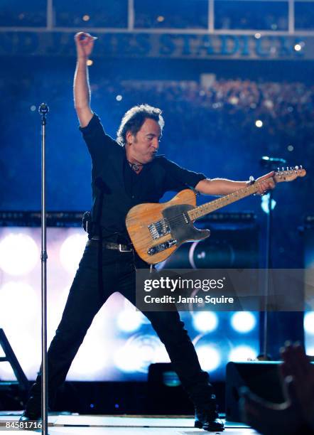 Musician Bruce Springsteen and the E Street Band perform at the Bridgestone halftime show during Super Bowl XLIII between the Arizona Cardinals and...