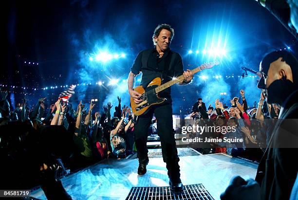 Musician Bruce Springsteen and the E Street Band perform at the Bridgestone halftime show during Super Bowl XLIII between the Arizona Cardinals and...