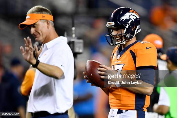Trevor Siemian of the Denver Broncos jokes with offensive coordinator Mike McCoy before the first quarter on Monday, September 11, 2017. The Denver...