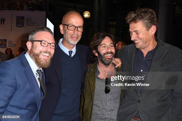 Eric Fellner second from , Tim Bevan and guests attend the "Darkest Hour" premiere during the 2017 Toronto International Film Festival at Roy Thomson...