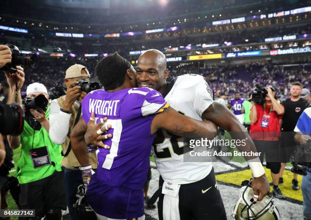 Jarius Wright of the Minnesota Vikings embraces former teammate Adrian Peterson of the New Orleans Saints after the game on September 11, 2017 at...