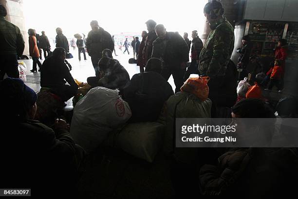Migrant workers arrive at the West Railway Station with their luggage on February 2, 2009 in Beijing, China. After Chinese New Year holiday,...