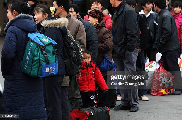 Migrant workers arrive at the West Railway Station with their luggage on February 2, 2009 in Beijing, China. After Chinese New Year holiday,...