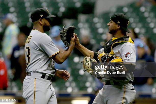 Felipe Rivero and Elias Diaz of the Pittsburgh Pirates celebrate after beating the Milwaukee Brewers 7-0 at Miller Park on September 11, 2017 in...