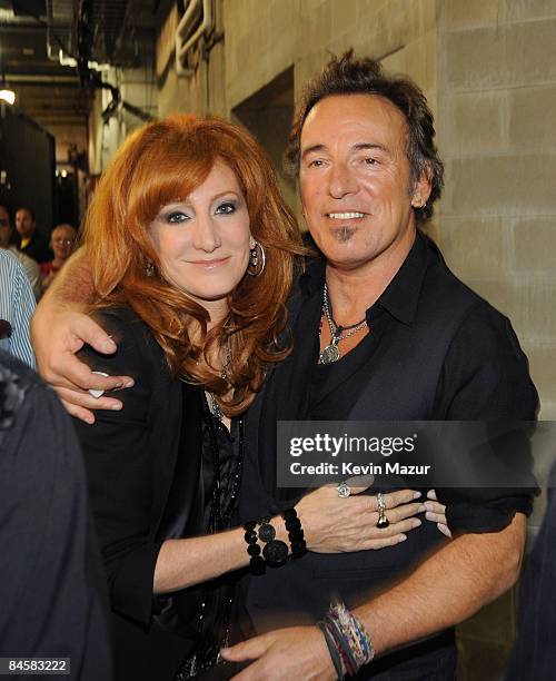 Singer Patti Scialfa and musician Bruce Springsteen pose backstage at the Bridgestone halftime show during Super Bowl XLIII between the Arizona...