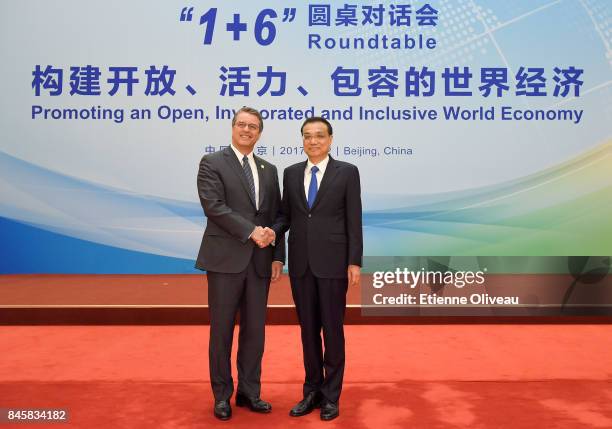 Director-General Roberto Azevedo of the World Trade Organization shakes hands with Chinese Premier Li Keqiang before The 1+6 Round Table Dialogue...