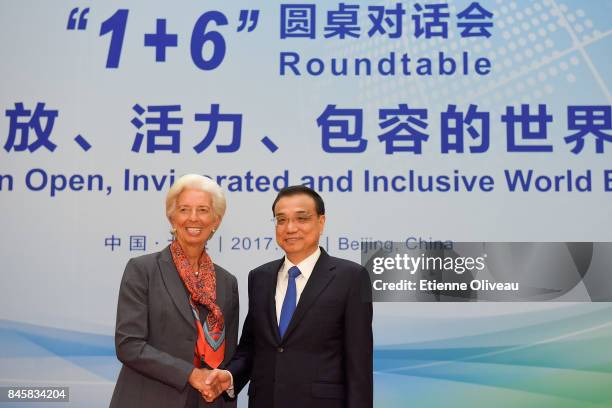 Managing Director Christine Lagarde of the International Monetary Fund shakes hands with Chinese Premier Li Keqiang before The 1+6 Round Table...