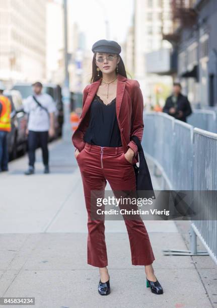 Chriselle Lim wearing red suit, flat cap seen in the streets of Manhattan outside Zimmermann during New York Fashion Week on September 11, 2017 in...
