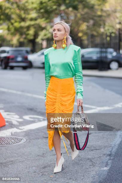 Julia Kuczynska wearing green top, yellow skirt, Gucci bag seen in the streets of Manhattan outside Zimmermann during New York Fashion Week on...