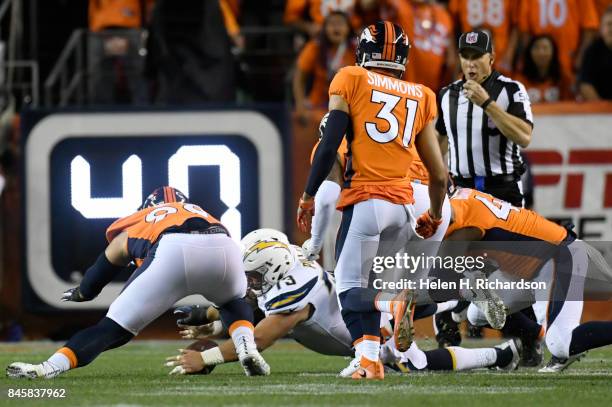 Spencer Pulley of the Los Angeles Chargers recovers the ball during the first quarter of action. The Denver Broncos hosted the Los Angeles Chargers...