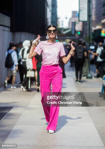 Giovanna Engelbert wearing pink velvet pants seen in the streets of Manhattan outside Derek Lam during New York Fashion Week on September 11, 2017 in...