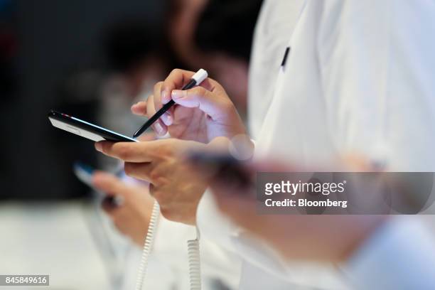 An attendee uses the S Pen stylus as he tries out the Samsung Electronics Co. Galaxy Note 8 smartphone during a media event in Seoul, South Korea, on...