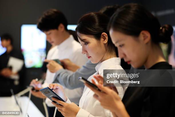 Attendees try out Samsung Electronics Co. Galaxy Note 8 smartphones during a media event in Seoul, South Korea, on Tuesday, Sept. 12, 2017. Samsung's...