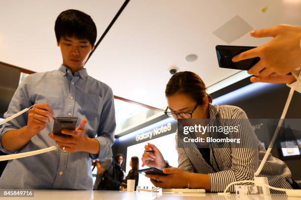 Attendees try out Samsung Electronics Co. Galaxy Note 8 smartphones during a media event in Seoul, South Korea, on Tuesday, Sept. 12, 2017. Samsung's...